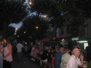 Evening market: crowds from the village and beyond sit down to eat together in the main street