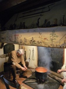 Getting the fire blazing with bellows.