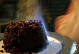 A Christmas pudding surrounded by brandy-induced flames.  Wikimedia Commons.