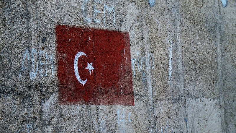 Turkish flag painted on the side of a building.