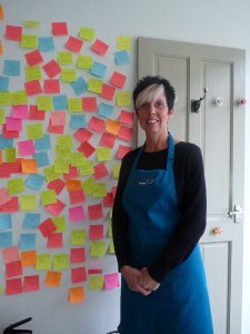 Here's Corrina, in her bright pinny, ready to welcome customers.