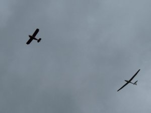 A glider is towed upwards on a windy day.