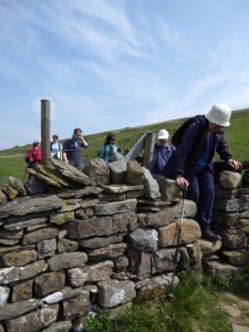 Slipping through a narrow stile.
