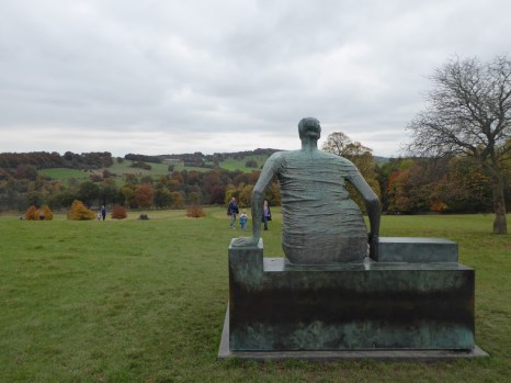 Henry Moore's 'Draped Seated Woman' looks down over the distant wooded lake.
